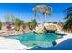 Resort-style pool with a rock waterfall and lush landscaping, creating a private retreat at 2678 E Firestone Dr, Chandler, AZ 85249