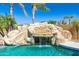 Close-up of a custom rock waterfall cascading into a sparkling pool, creating a backyard oasis at 2678 E Firestone Dr, Chandler, AZ 85249