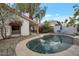 Backyard features a refreshing pool, mature landscaping, and a charming patio seating area at 3022 E Weldon Ave, Phoenix, AZ 85016