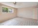 Bright bedroom with a ceiling fan, patterned floors and natural light streaming through a window at 3022 E Weldon Ave, Phoenix, AZ 85016