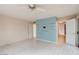 Bedroom featuring white tile floors, ceiling fan, a light blue accent wall and white shelving at 3022 E Weldon Ave, Phoenix, AZ 85016