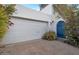 Spacious two-car garage featuring a white door and a blue accent door at 3022 E Weldon Ave, Phoenix, AZ 85016