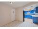 Bright kitchen featuring vibrant blue cabinetry, light countertops, and modern appliances at 3022 E Weldon Ave, Phoenix, AZ 85016