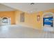 Spacious living area boasting abundant natural light, arched doorway, and view of a blue kitchen at 3022 E Weldon Ave, Phoenix, AZ 85016