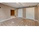 Living room featuring tiled floor, two white closets, and connecting doorway to other rooms at 3022 E Weldon Ave, Phoenix, AZ 85016