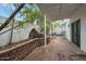 Private patio with brick flooring, a rock water feature, and mature trees at 3022 E Weldon Ave, Phoenix, AZ 85016