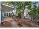 Outdoor patio area with brick flooring, table, and lush greenery at 3022 E Weldon Ave, Phoenix, AZ 85016