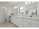 Bathroom featuring dual sinks, a marble countertop, and ample cabinet space at 309 W Campbell Ave, Phoenix, AZ 85013