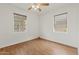 An empty bedroom with wood floors and bright windows at 309 W Campbell Ave, Phoenix, AZ 85013