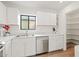 Bright kitchen features stainless steel appliances, white cabinets, and a view from the window at 309 W Campbell Ave, Phoenix, AZ 85013