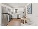 Well-lit kitchen features stainless steel appliances, white cabinetry, and modern countertops at 309 W Campbell Ave, Phoenix, AZ 85013