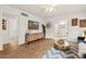 Bright living room features wood floors, a modern ceiling fan, and a stylish coffee table at 309 W Campbell Ave, Phoenix, AZ 85013