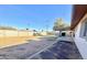 Open backyard with a large block wall and a covered patio at 3133 N 81St Ave, Phoenix, AZ 85033