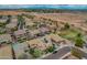 Neighborhood aerial view showing a community with homes, desert landscapes, and an open desert area off in the distance at 3712 S 104Th Ln, Tolleson, AZ 85353