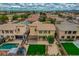 Aerial view of the property featuring a backyard with a pergola and outdoor kitchen, complemented by mature landscaping at 3712 S 104Th Ln, Tolleson, AZ 85353