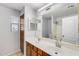 Well-lit bathroom with double sinks, a large mirror, and a shower/tub combination at 3712 S 104Th Ln, Tolleson, AZ 85353