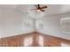 Spacious bedroom featuring wood floors, a ceiling fan, and large windows at 3712 S 104Th Ln, Tolleson, AZ 85353