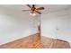 This bedroom has wood-look floors and a ceiling fan and includes access to an ensuite bathroom at 3712 S 104Th Ln, Tolleson, AZ 85353