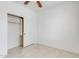 Bedroom featuring neutral colored walls, tile flooring, and a closet with sliding doors at 3712 S 104Th Ln, Tolleson, AZ 85353