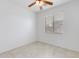 Bedroom featuring neutral colored walls, tile flooring, and a window with blinds at 3712 S 104Th Ln, Tolleson, AZ 85353