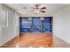 Bedroom with a blue wall-mounted bookshelf and hardwood flooring, creating a modern and cozy space at 3712 S 104Th Ln, Tolleson, AZ 85353