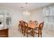 Elegant dining room featuring a chandelier, and a view of an open doorway leading to the kitchen at 3712 S 104Th Ln, Tolleson, AZ 85353