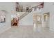 Grand foyer with a soaring ceiling, open staircase, and neutral tile flooring throughout the main level at 3712 S 104Th Ln, Tolleson, AZ 85353