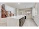 View of the kitchen island with a staircase, and lots of natural light enhancing the living space at 3712 S 104Th Ln, Tolleson, AZ 85353