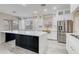 Kitchen featuring white cabinetry, stainless steel appliances and a black island with white countertop at 3712 S 104Th Ln, Tolleson, AZ 85353