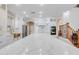 Kitchen featuring an expansive island with waterfall quartz countertop, white cabinets and stainless steel appliances at 3712 S 104Th Ln, Tolleson, AZ 85353