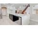 Kitchen area with an extended waterfall island and wood staircase enhancing the open floor plan at 3712 S 104Th Ln, Tolleson, AZ 85353