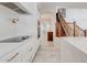 A modern kitchen with stainless steel appliances, stone countertops, and a view to a wood staircase at 3712 S 104Th Ln, Tolleson, AZ 85353