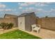 Backyard shed with a white bench and mature landscaping at 3712 S 104Th Ln, Tolleson, AZ 85353