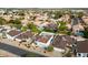 Overhead angle of a residential neighborhood displaying mature trees, sparkling pools and tree lined streets at 406 W Fellars Dr, Phoenix, AZ 85023