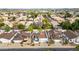 Aerial view of neighborhood featuring well-maintained homes, lush landscaping, and sparkling swimming pools at 406 W Fellars Dr, Phoenix, AZ 85023