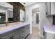 Stylish bathroom with marble countertops, decorative mirrors and a walk-in closet at 406 W Fellars Dr, Phoenix, AZ 85023