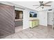 Bedroom showcasing a sliding barn door and a modern television for a relaxing space at 406 W Fellars Dr, Phoenix, AZ 85023