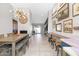 Bright dining area featuring a long table, decorative lighting, and unique wall decor, creating a stylish ambiance at 406 W Fellars Dr, Phoenix, AZ 85023