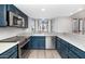 Well-lit kitchen features stainless steel appliances, navy cabinets, and a sink with a window above at 406 W Fellars Dr, Phoenix, AZ 85023