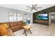 Bright living room with tile floors, a statement wall with a television, and sliding glass doors to the patio at 406 W Fellars Dr, Phoenix, AZ 85023