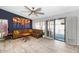 Bright living room with tile floors, a statement wall with a television, and sliding glass doors to the patio at 406 W Fellars Dr, Phoenix, AZ 85023