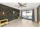 Relaxing living space with unique dark wood paneling, a ceiling fan, and sliding glass doors at 406 W Fellars Dr, Phoenix, AZ 85023