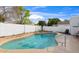 Refreshing pool featuring in-water stools, a sleek railing, and manicured desert landscaping at 406 W Fellars Dr, Phoenix, AZ 85023