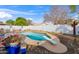 Backyard oasis with diving board and a sparkling pool surrounded by desert landscaping and lounge area at 406 W Fellars Dr, Phoenix, AZ 85023