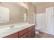 Neutral bathroom features a large vanity, a mirror, and a shower-tub combination with a white shower curtain at 4116 W Milada Dr, Laveen, AZ 85339