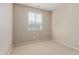 Neutral bedroom featuring a window with blinds, beige carpet, and baseboards at 4116 W Milada Dr, Laveen, AZ 85339