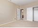 Neutral bedroom with carpet, slider closet doors, and a view of the bathroom at 4116 W Milada Dr, Laveen, AZ 85339