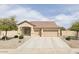 Charming single-story home with a well-manicured front yard and a three-car garage at 4116 W Milada Dr, Laveen, AZ 85339