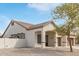 Beige single-story home with a covered entrance and tiled roof, offering stylish curb appeal and desert landscaping at 4116 W Milada Dr, Laveen, AZ 85339