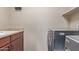 Modern laundry room featuring a sink, washer and dryer, and wooden cabinets at 4116 W Milada Dr, Laveen, AZ 85339